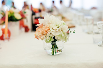 flowers in the vase on the banquet table