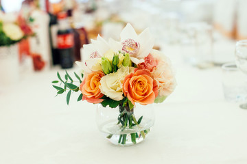 flowers in the vase on the banquet table