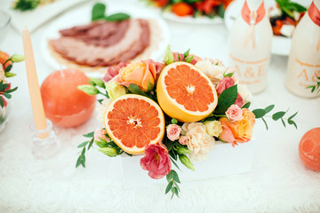 decoration of grapefruit with flowers on the table