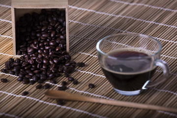 Coffee cup and coffee beans on table