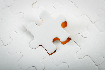 Completing final task, missing jigsaw puzzle pieces and business concept with a final puzzle piece...