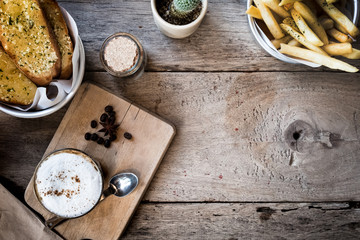 Top view of a red cup of hot coffee put on a wooden table.Vintage tone with copy space.