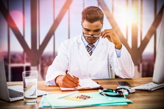 Composite image of doctor writing on clipboard at desk