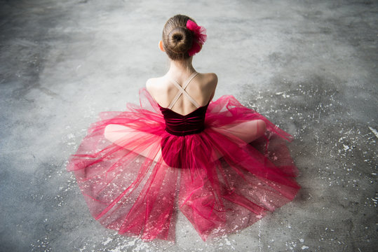 little ballerina sitting on floor back
