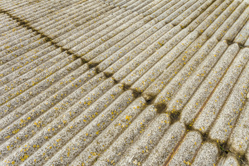 Asbestos cement sheets. Texture of old laid roofing sheets. Grey old roof.