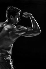 Fototapeta na wymiar Strong Athletic Man Fitness Model posing back muscles, triceps o
