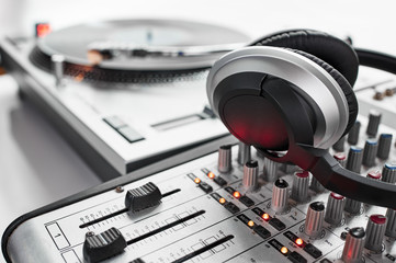 headphones a turn table, and a mixing board
