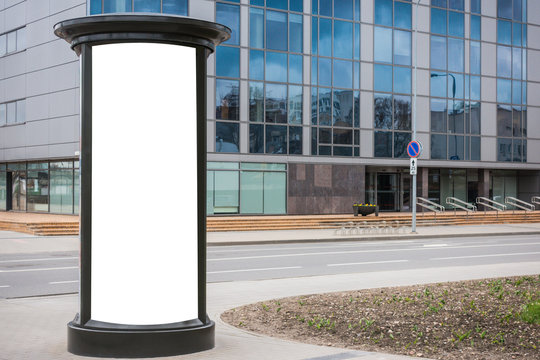 Mock up. Blank outdoor advertising column outdoors, public information board in the street.
