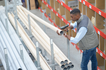 Man scanning plastic tubes in store