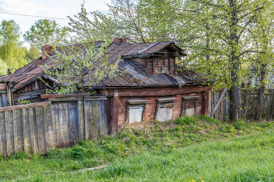 A small wooden house, ingrown into the ground on the outskirts