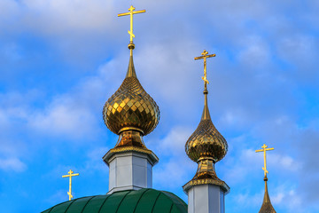 Fototapeta na wymiar Gold-plated domes with crosses of the Orthodox church