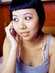 Teenage girl using cellular telephone