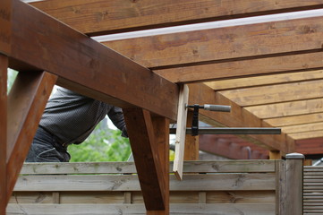 Terrassenüberdachung - Pergola aus Holz montieren - obrazy, fototapety, plakaty
