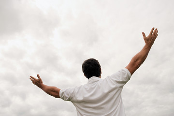 Man worshipping with open arms