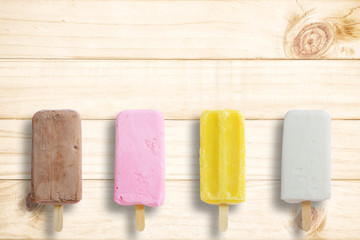 Ice cream stick put on wood background with copy space.