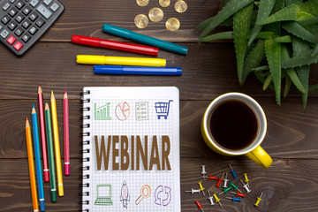 Businessman left a notes  WEBINAR with pencil in Notepad on the desktop.