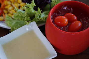 Fresh tomato in a red cup of ice, cold tomato it for health