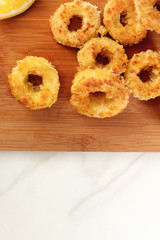 Closeup of fried calamari rings with lemon and copyspace
