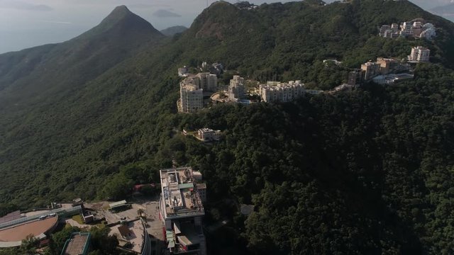 Hong Kong Aerial v8 Flying over The Peak area panning with cityscape views.