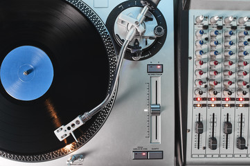 a turntable and mixing board in a recording studio