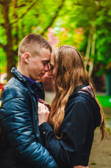 The guy and the girl are hugging each other. Romantic walk