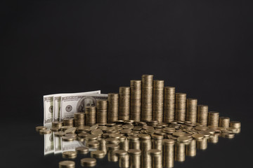 photo of piles of coins in the shape of a pyramid on the grey background
