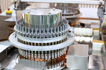 Automatic optical inspection machine, inspects vials and ampules for particulates in liquid and container defects. 