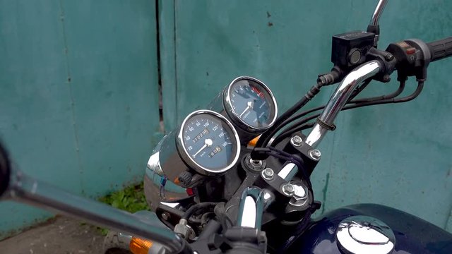 Zoom out of motorcycle speedometer. 4k video