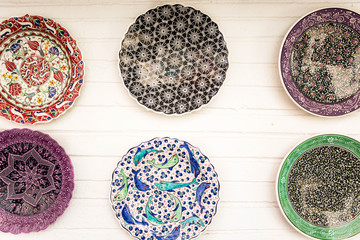 Decorative souvenir plates on white wall background, Turkey, Kalkan.