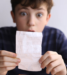teenager boy shocked expression after see bill for pizza in fast food restaurant