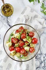 Mozzarella and cherry tomatoes salad with pesto sauce 