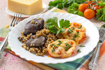 Buckwheat with stewed chicken liver and tomatoes baked with cheese