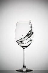 wineglass with splashing liquid