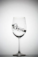 wineglass with splashing liquid