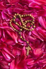 Rosary beads on flower background.