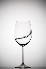 wineglass with splashing liquid