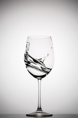 wineglass with splashing liquid