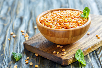 Dry yellow peas in a wooden bowl.