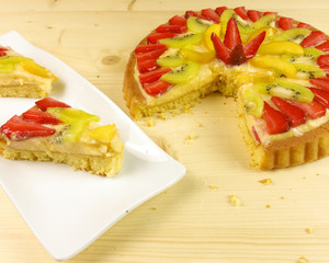 Fruit tart on wooden background - top view