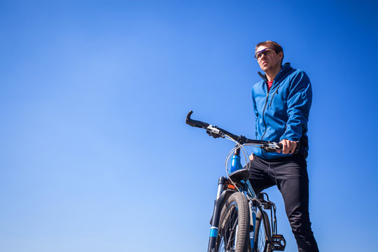 Young Bicyclist Against The Sky