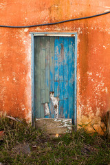Old blue colored door in abandoned house in countryside