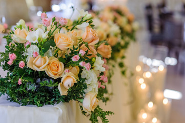 wedding flower arrangement on the background of burning candles