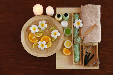 Beautiful spa composition of manicure tools and plate on wooden background