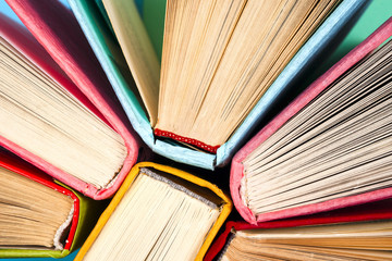 Top view of bright colorful hardback books in a circle.