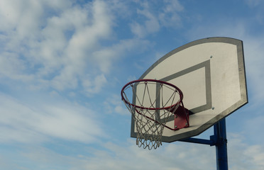 Basketball shield against the blue sky