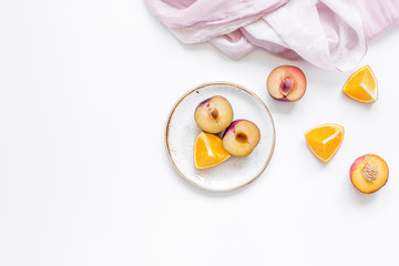 woman summer breackfast with orange and peach fruits and fabric on white background flat lay mockup