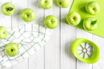 ripe green apples with towel white table background top view
