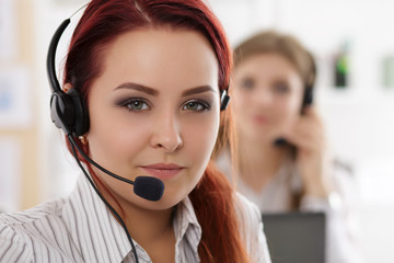 Portrait of call center worker accompanied by her team