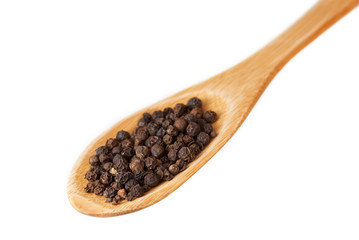 Black pepper in wooden spoon isolated on white