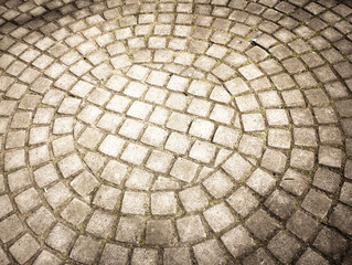 Pavement laid out in a semi-circle and round, smooth stones. Paving stone, tile, semicircle and circle...